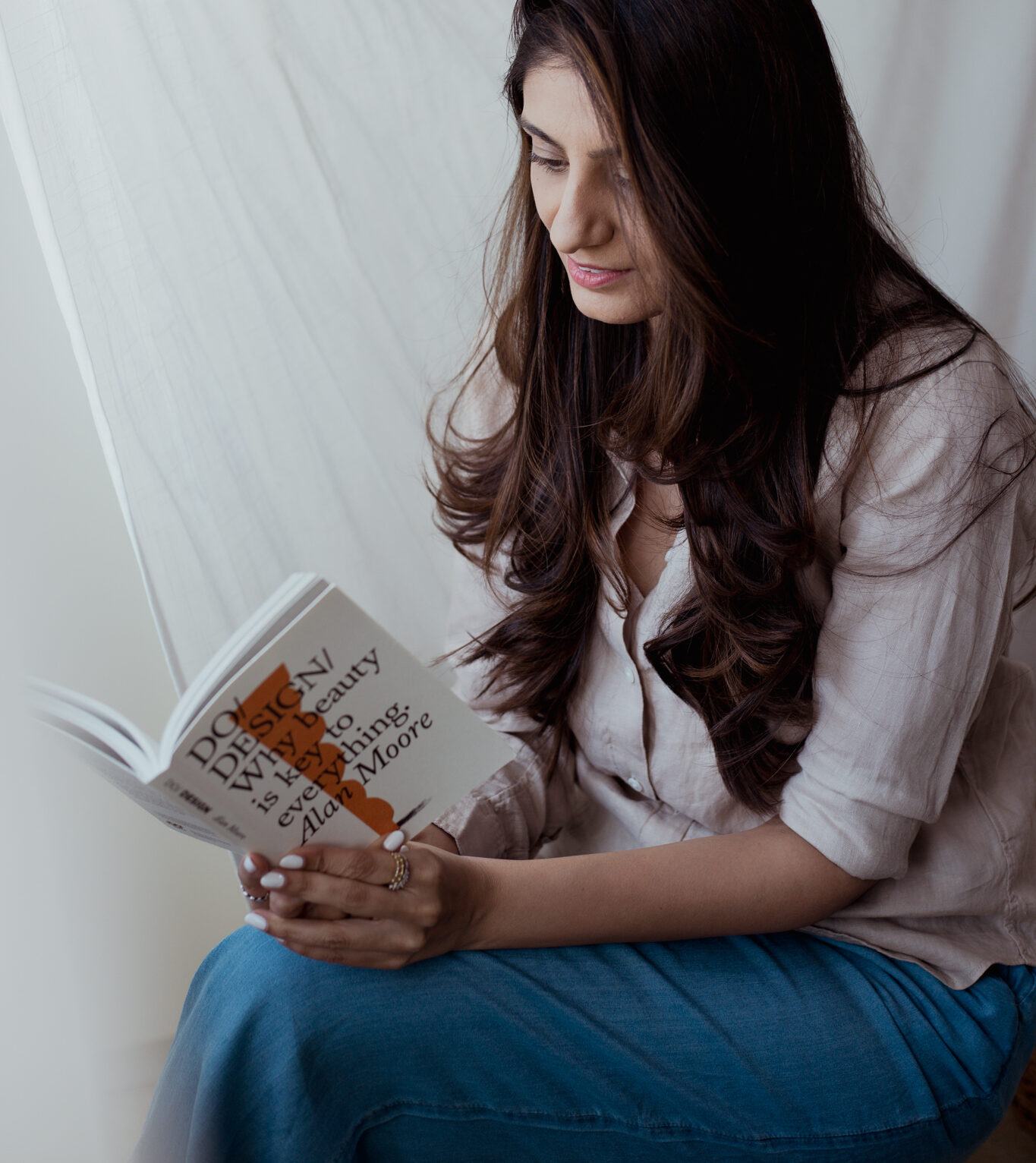 artist reading book for inspiration